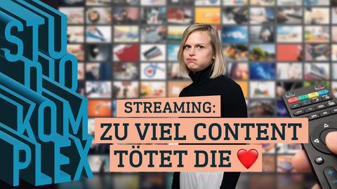 Unsere Hostin Anne schaut überfordert in die Kamera, sie hat die Qual der Wahl im Streaming Angebot. Im Hintergrund ist eine ganze Wand an Bildschirmen, die unterschiedliche Filme zeigt. Im rechten Vordergrund sieht man eine Fernbedienung, die gerade bedient wird.