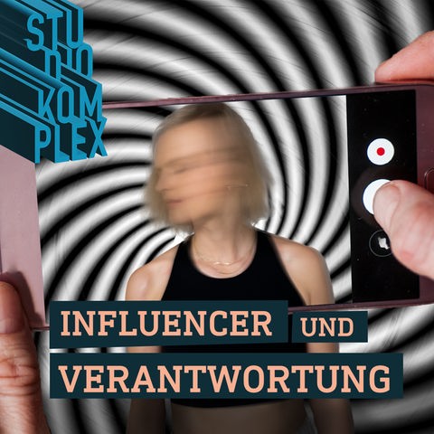 Das Bild scheint, als sei der Betrachter derjenige, der das Handy in den Händen hält und die Hostin Anne als Influencerin filmt. Es scheint, als bewege sie ihren Kopf sehr schnell zur Seite, da das Bild grafisch verwischt ist.