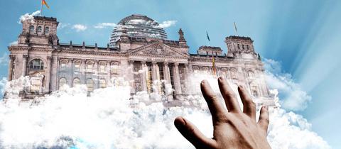 Eine Hand greift nach dem Bundestag