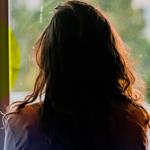 Frau schaut aus einem Fenster